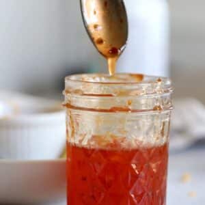 Sweet Chili Sauce dripping from a spoon