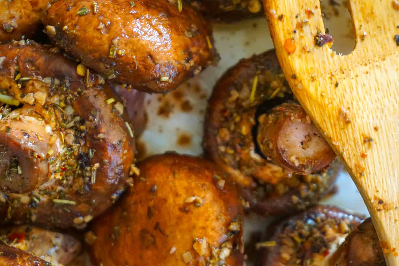 Bella mushrooms in a skillet with butter and Italian seasoning