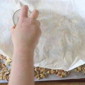spreading granola with extra parchment paper