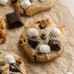 smores cookies on a baking sheet with chocolate and marshmallows