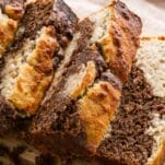 marbled slices of keto banana nut bread in a pile with loaf