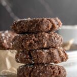 stack of coookies with coconut flakes scattered about