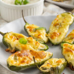 jalapeño poppers with golden cheesy crust and green onion garnish