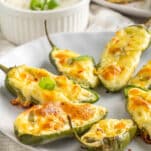 golden cheesy jalapeño poppers arranged on a plate with ranch dressing